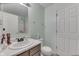 Bright bathroom features a neutral countertop, well-lit mirror, and updated fixtures for a clean design at 11117 Waterfield Pl, Indianapolis, IN 46235