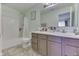 Bright bathroom features a shower and tub combo, dual sinks, and ample counter space at 11117 Waterfield Pl, Indianapolis, IN 46235