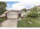 Charming home featuring a manicured front yard with a lush green lawn and mature tree at 11117 Waterfield Pl, Indianapolis, IN 46235