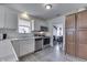 Well-lit kitchen featuring stainless steel appliances, white cabinets, and a view into the dining area at 11117 Waterfield Pl, Indianapolis, IN 46235