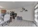 Open-concept room featuring wood flooring, natural light, and a back door at 11117 Waterfield Pl, Indianapolis, IN 46235