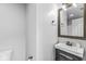 Bathroom vanity with dark wood finish, a silver faucet, and a gray countertop at 11222 Boston Way, Fishers, IN 46038