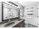 Modern bathroom featuring a double sink vanity, decorative tile floor, and subway tiled shower at 11222 Boston Way, Fishers, IN 46038