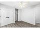 Neutral bedroom with wood floors, ceiling fan and a double door closet at 11222 Boston Way, Fishers, IN 46038