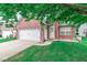 Charming brick home with a two-car garage, a well-manicured lawn, and a cozy front entrance at 11222 Boston Way, Fishers, IN 46038