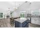 Open concept kitchen and living area with stainless steel appliances, island, and inviting fireplace at 11222 Boston Way, Fishers, IN 46038