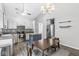 Updated kitchen with dining area featuring stainless steel appliances, an island, and stylish decor at 11222 Boston Way, Fishers, IN 46038
