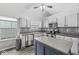 Well-lit kitchen with black and white tile backsplash, an island, stainless appliances, and a window view at 11222 Boston Way, Fishers, IN 46038