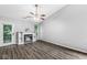 Comfortable living room with a fireplace, built-in shelves, a ceiling fan, and natural light at 11222 Boston Way, Fishers, IN 46038