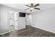 Comfortable bedroom with wood-look floors, ceiling fan, and a view into the en suite bathroom at 11222 Boston Way, Fishers, IN 46038