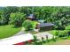 Aerial view showcases the property with outbuildings, a large lawn, and mature trees at 1155 Cope Rd, Martinsville, IN 46151