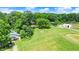 Aerial view showcases property with various buildings, mature trees, and expansive green space at 1155 Cope Rd, Martinsville, IN 46151
