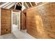 View of carpeted attic space with wooden walls and ceiling and a ladder leading to the floor below at 1155 Cope Rd, Martinsville, IN 46151