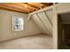Bright attic room with dormer ceilings and neutral walls features a window and easy closet access at 1155 Cope Rd, Martinsville, IN 46151