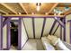 Relaxing attic room with exposed beams and painted trim offers an inviting seating area and closet at 1155 Cope Rd, Martinsville, IN 46151