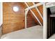 Bright attic room featuring wooden walls, vaulted ceilings with wooden beams, and a circular window at 1155 Cope Rd, Martinsville, IN 46151