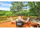 Outdoor deck featuring a built-in fire pit with seating and beautiful backyard views at 1155 Cope Rd, Martinsville, IN 46151