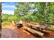 Outdoor deck featuring a fire pit with seating and a picnic table, offering beautiful backyard views at 1155 Cope Rd, Martinsville, IN 46151