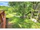 Backyard view featuring a pond, wooden platform, and treehouse, blending outdoor living with nature at 1155 Cope Rd, Martinsville, IN 46151