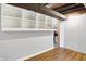 Unfinished basement with built-in shelves and wood-look flooring at 1155 Cope Rd, Martinsville, IN 46151