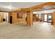 Large basement with carpet and paneled walls, offering potential as a recreation or entertainment space at 1155 Cope Rd, Martinsville, IN 46151
