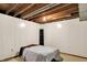 Basement bedroom with carpet floors, paneled walls, and an exposed ceiling, perfect for customization at 1155 Cope Rd, Martinsville, IN 46151