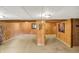 Basement with carpet floors, wood paneled support beam and wood walls, offering a cozy and functional space at 1155 Cope Rd, Martinsville, IN 46151
