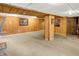 Spacious basement featuring wood-paneled walls, carpet floors, and a vintage phone display at 1155 Cope Rd, Martinsville, IN 46151