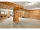 Basement space featuring paneled walls, carpet flooring, and a walkout to the backyard at 1155 Cope Rd, Martinsville, IN 46151