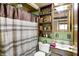 Cozy bathroom featuring striped shower curtain, shelves, vanity, sink, and fixtures at 1155 Cope Rd, Martinsville, IN 46151