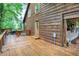 View of the spacious wooden deck with a hot tub overlooking a wooded area at 1155 Cope Rd, Martinsville, IN 46151