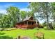 Charming log cabin with a wraparound porch and lush green lawn, perfect for outdoor living at 1155 Cope Rd, Martinsville, IN 46151
