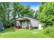 Exterior building featuring a large roll-up door, side door, and surrounded by green grass and trees at 1155 Cope Rd, Martinsville, IN 46151