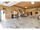 Large garage with wood paneling, open space, tables, seating, and multiple doors for easy access at 1155 Cope Rd, Martinsville, IN 46151