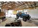 Large garage area features a vehicle, lighting, concrete floor, and plywood walls at 1155 Cope Rd, Martinsville, IN 46151