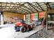 Spacious garage with wood truss ceiling and concrete floor includes equipment and storage at 1155 Cope Rd, Martinsville, IN 46151