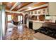 Well-lit kitchen showcases a view into the living room with dark appliances and unique flooring at 1155 Cope Rd, Martinsville, IN 46151