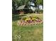 Garden view featuring colorful flowers, a birdbath, and the charming exterior of the house at 1155 Cope Rd, Martinsville, IN 46151