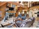 Cozy living room features a stone fireplace, wood beams, and comfortable seating at 1155 Cope Rd, Martinsville, IN 46151