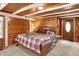 Cozy bedroom featuring wood walls, beamed ceilings, and plush carpeting at 1155 Cope Rd, Martinsville, IN 46151