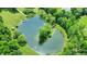 Scenic overhead view of a pond with an island connected by a bridge and a dock on the opposite shore at 1155 Cope Rd, Martinsville, IN 46151