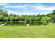 Picturesque pond area with a wooden dock and diving platform surrounded by green grass and lush trees at 1155 Cope Rd, Martinsville, IN 46151