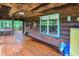 Covered porch with rustic wood, adorned with vintage decor, and overlooking nature at 1155 Cope Rd, Martinsville, IN 46151