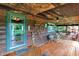 Rustic covered porch featuring outdoor seating and views of a beautiful landscape at 1155 Cope Rd, Martinsville, IN 46151