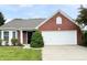 Charming brick home with a manicured lawn and attached two-car garage at 1173 Carlton Ct, Greenwood, IN 46143