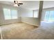 Spacious carpeted living space with multiple windows and sliding glass doors to the outdoors at 1173 Carlton Ct, Greenwood, IN 46143
