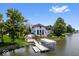 Aerial view of a beautiful home with a lakefront backyard, a pool, and a private dock at 12208 Island Dr, Indianapolis, IN 46256