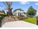 Landscaped backyard with a multi-level deck, tiered retaining wall, and lush green lawn at 12208 Island Dr, Indianapolis, IN 46256