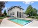 Backyard pool area with an inground pool, basketball court, and lake views at 12208 Island Dr, Indianapolis, IN 46256