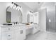 Bathroom featuring double vanities, modern fixtures, and walk-in shower at 12208 Island Dr, Indianapolis, IN 46256